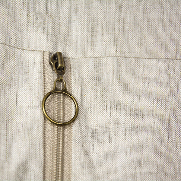 detail of the zip of a natural color garment bag