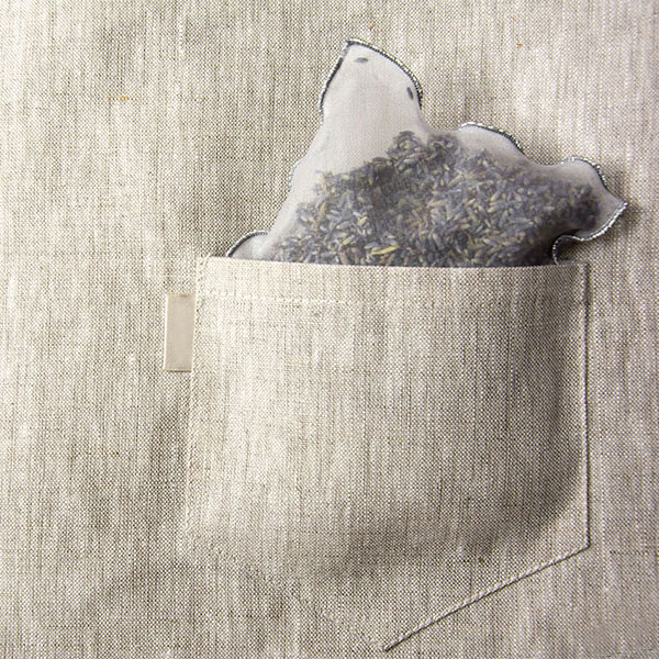 lavender bug in the pocket of a natural color garment bag