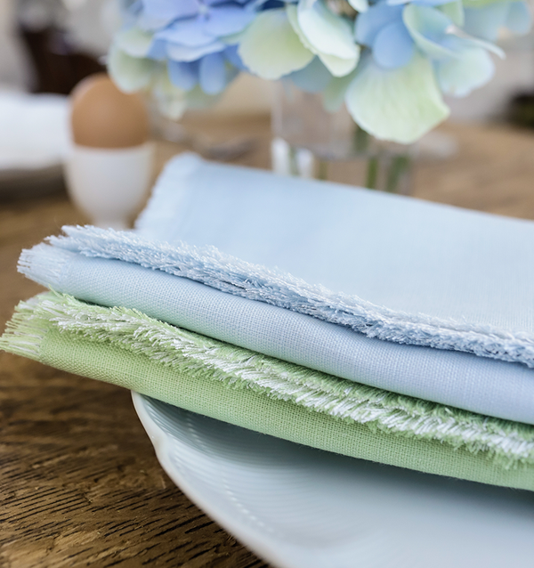 light blue and light green napkin on a white plate
