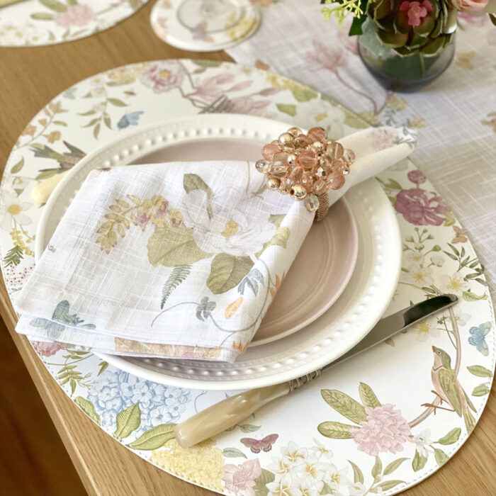 table setting with placemat with birds and flowers